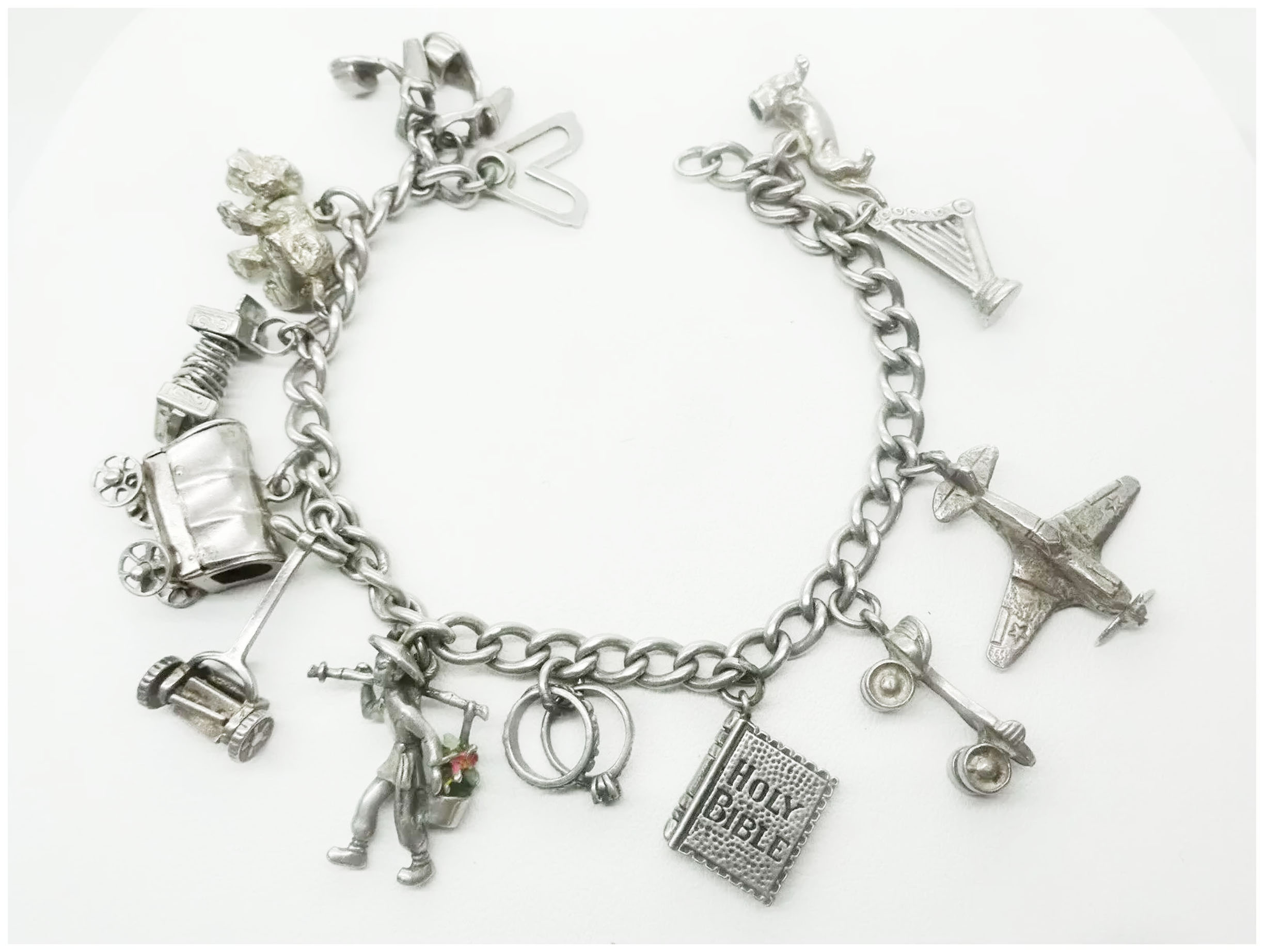 1/5 CT. T.W. Diamond Heart Assorted Charm Bracelet in Sterling Silver |  Zales